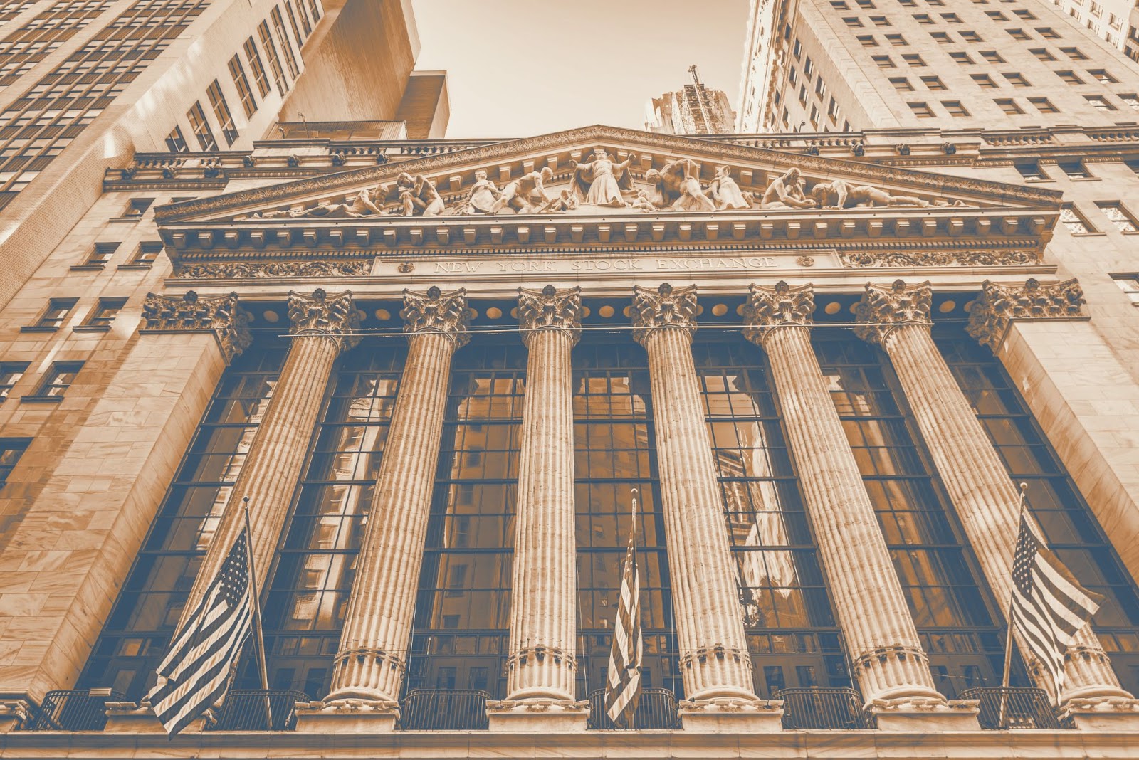New York Stock Exchange neoclassical facade with American flags and Corinthian columns in sepia tone