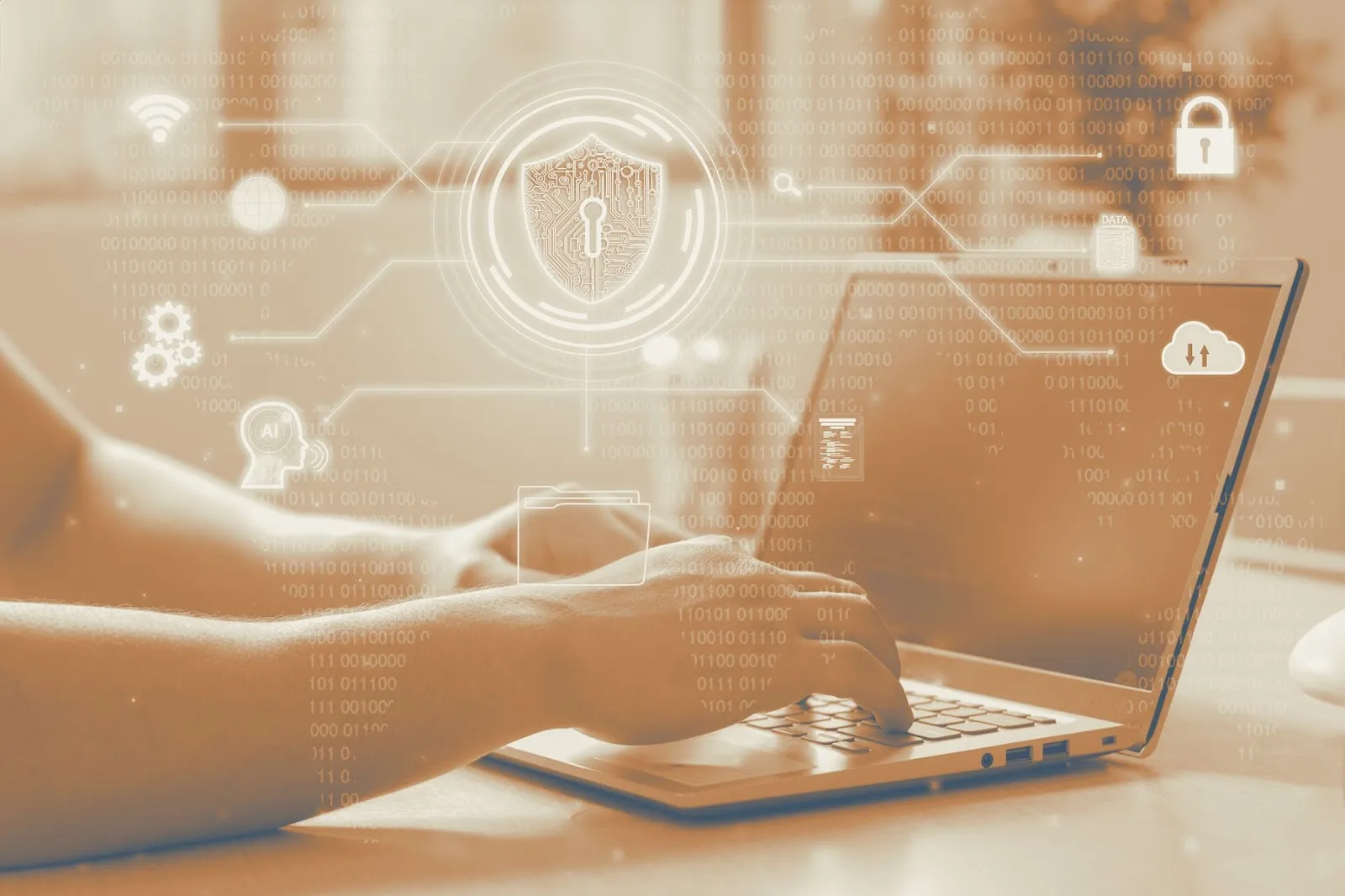 Person typing on a laptop with holographic cybersecurity icons including a shield, lock, cloud, and binary code